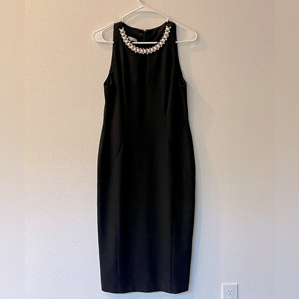 A black Maggie London dress with pearls and diamonds on the collar